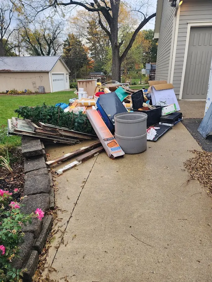 Dumpster being loaded with debris for Estate Cleanout Dumpster Rental in Midfield